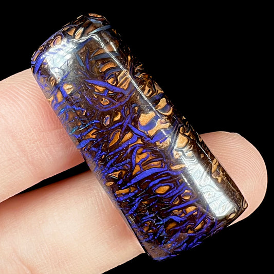 A loose boulder opal stone with purple veins from Koroit, Australia.