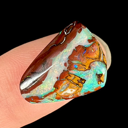 A polished matrix opal stone from Koroit, Australia.  The opal has a blue color.