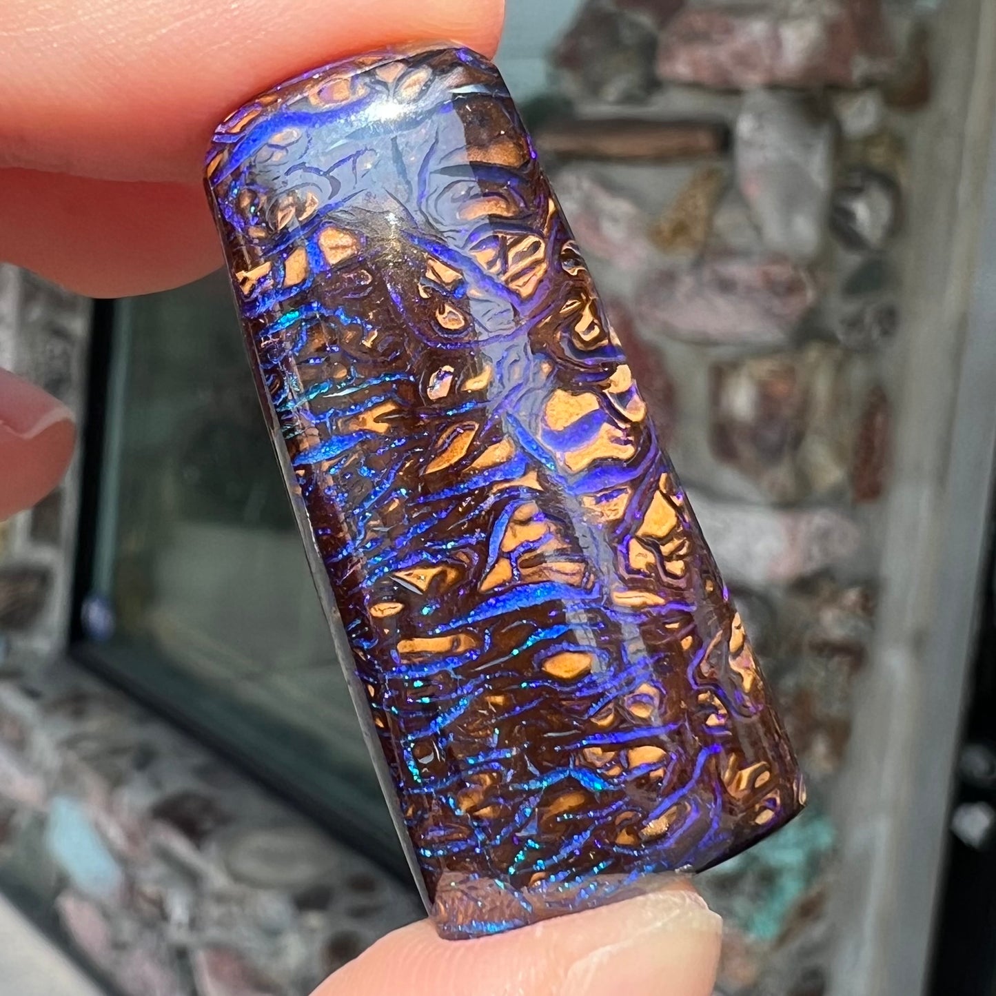 A loose boulder opal stone with purple veins from Koroit, Australia.