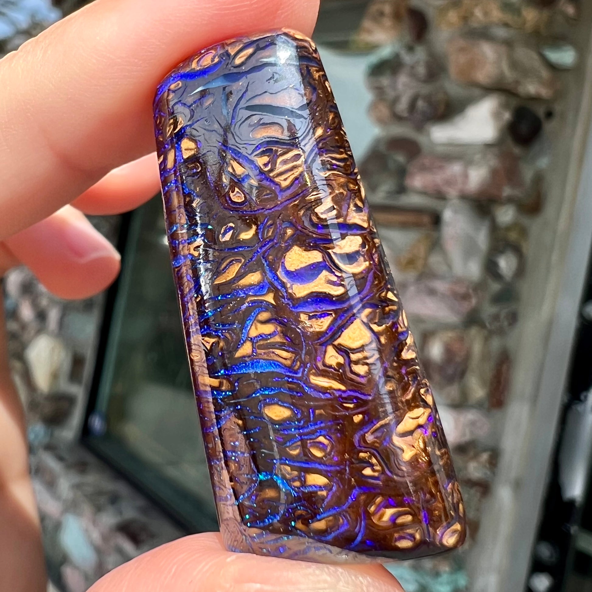 A loose boulder opal stone with purple veins from Koroit, Australia.