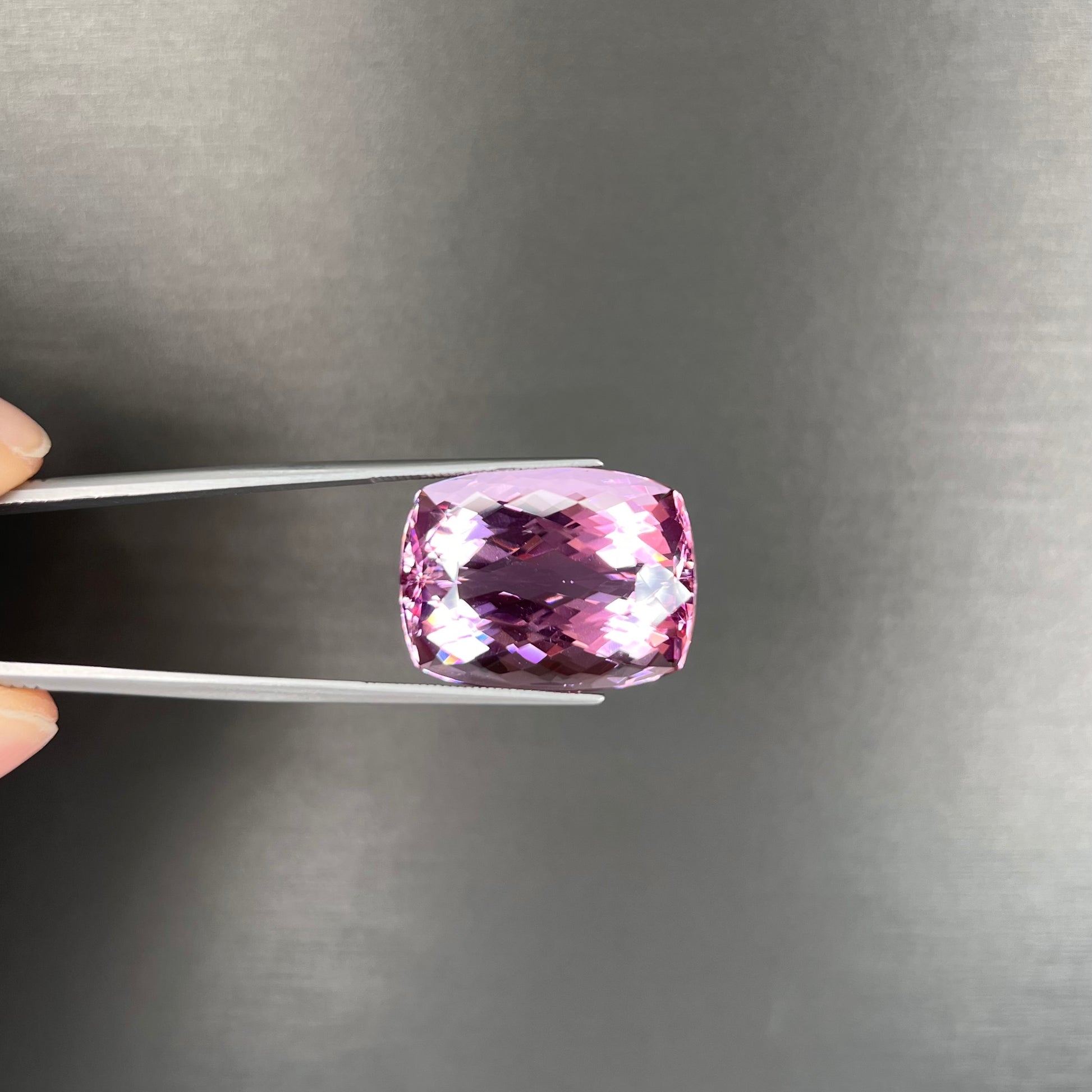 A modified cushion cut Afghanistan kunzite gemstone.  The stone is a purplish pink color and weighs 49.30 carats.