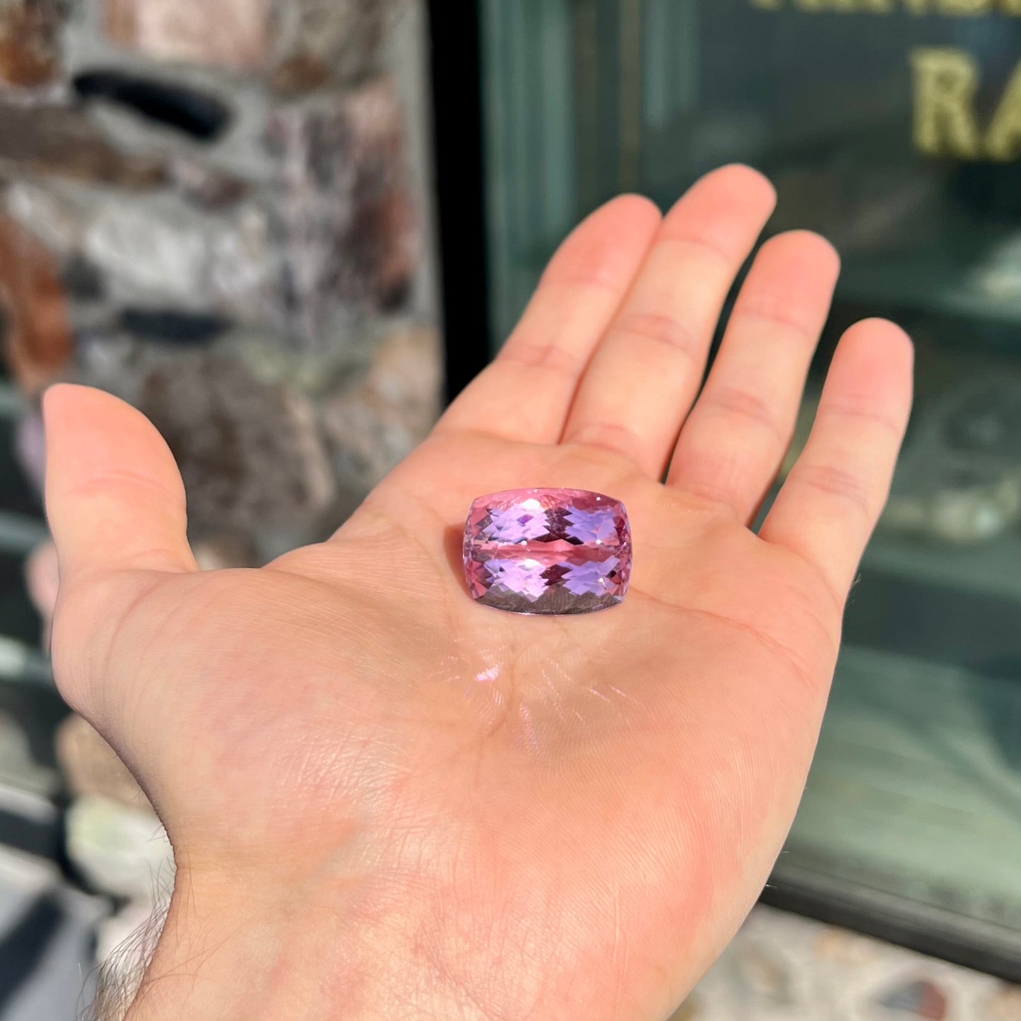 A modified cushion cut Afghanistan kunzite gemstone.  The stone is a purplish pink color and weighs 49.30 carats.