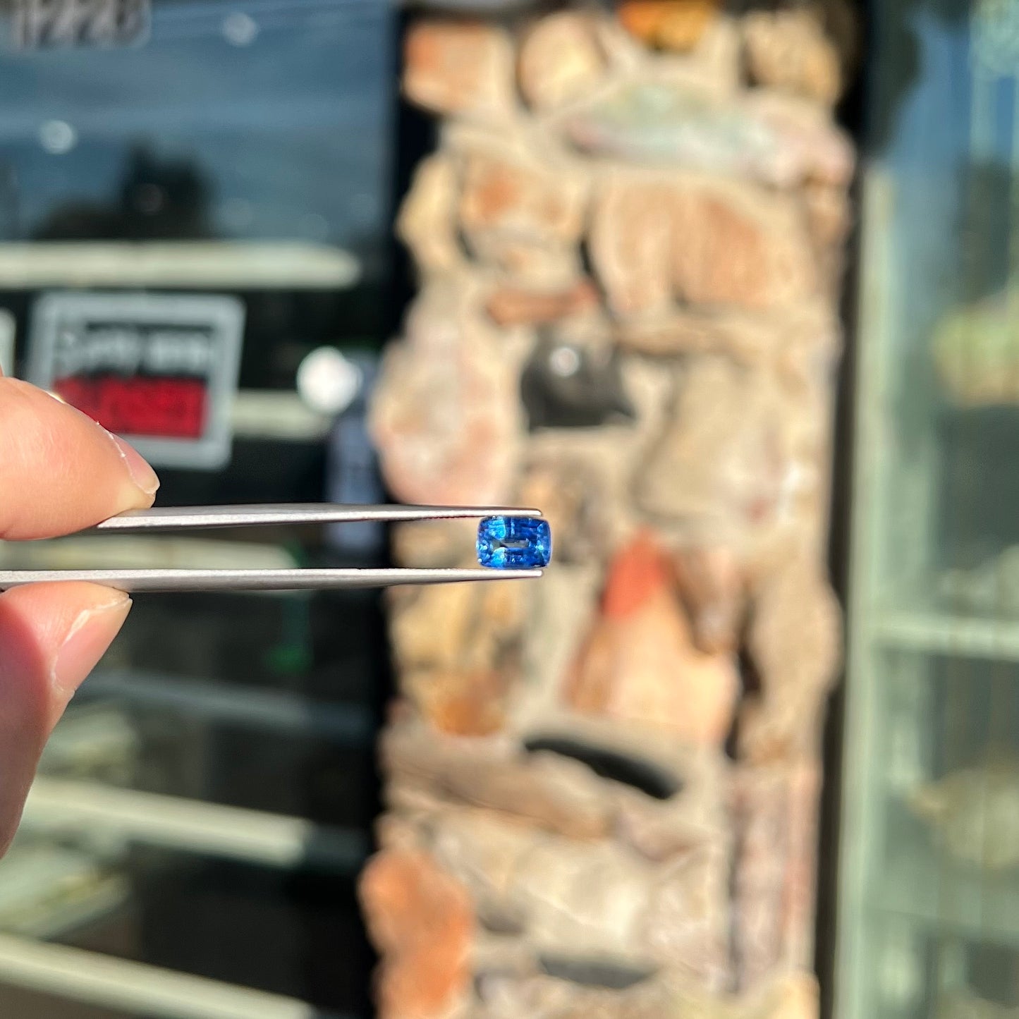 A loose, blue kyanite gemstone.  The stone is a faceted cushion cut.