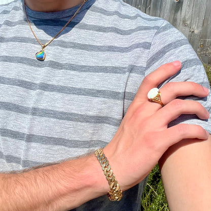 A yellow gold solitaire cocktail ring mounted with a natural white opal from Coober Pedy, Australia.