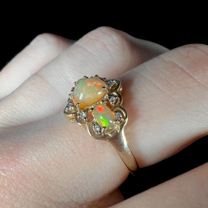 A three-stone gold ring set with Ethiopian fire opals and diamond accents.