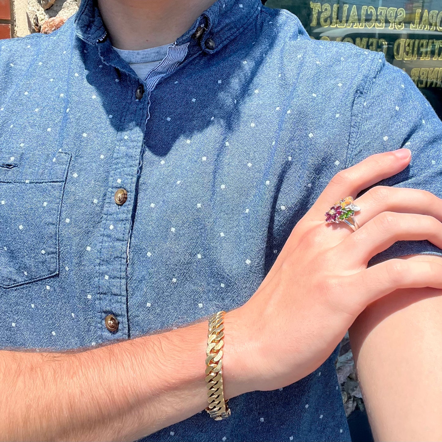 A ladies' gemstone flower design cluster ring set with Ethiopian fire opals, chrome diopsides, rhodolite garnets, and white topaz stones.