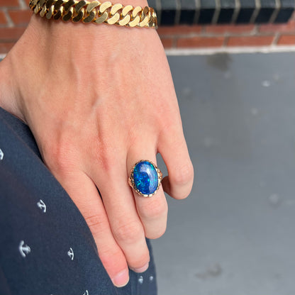 A ladies' vintage, 1940's style black opal doublet ring in yellow gold.