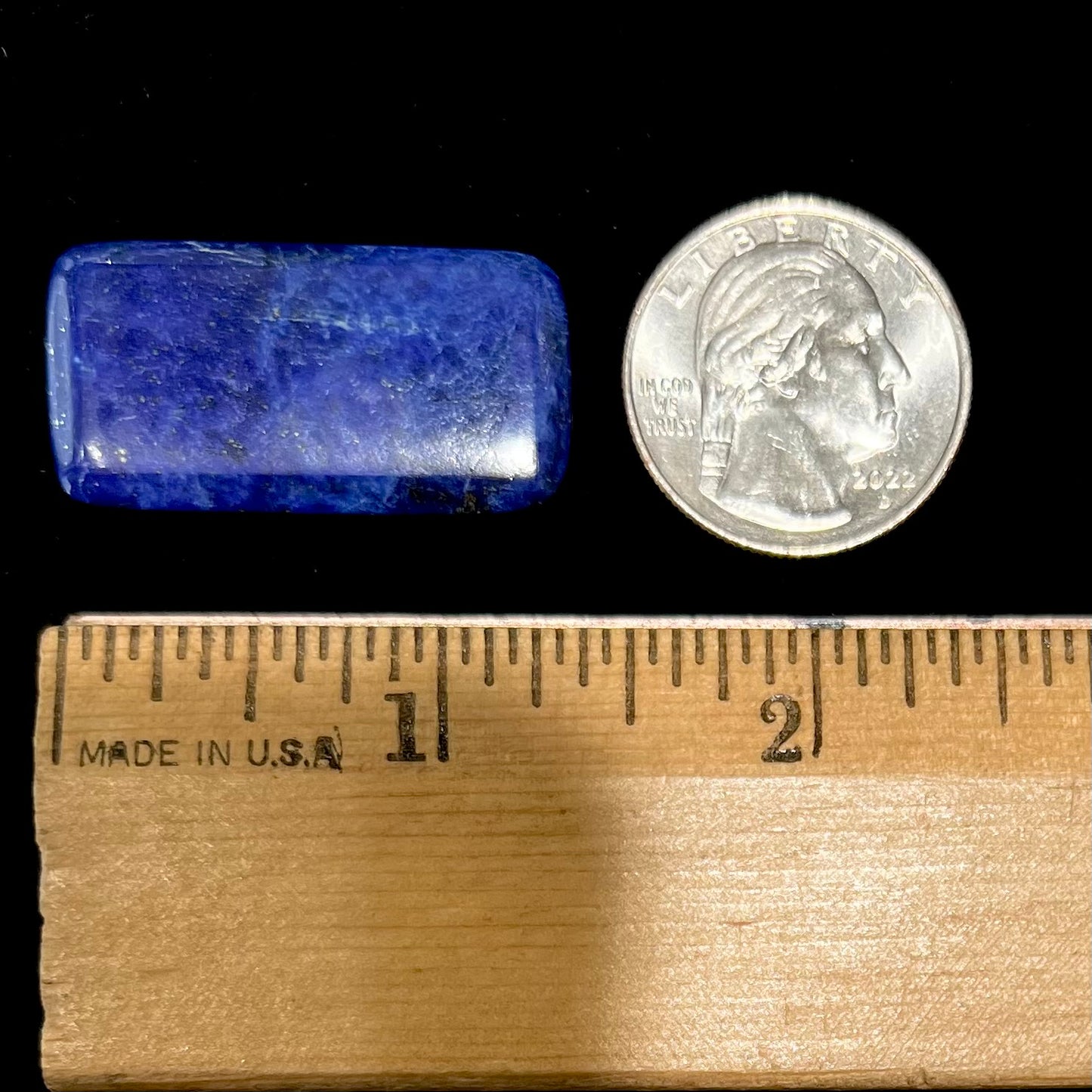 A loose, rectangle cabochon cut AA grade blue lapis lazuli stone.