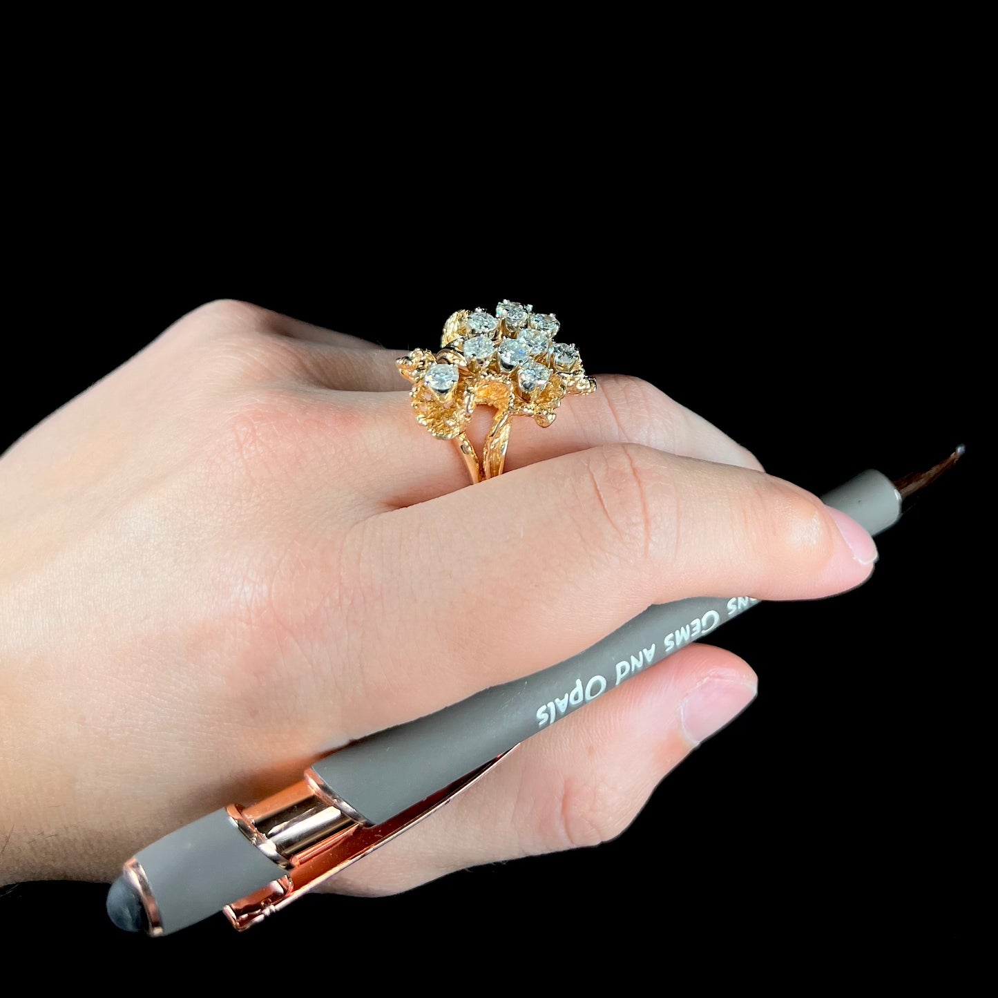 A ladies' 1950's style yellow gold and diamond cluster ring.  The ring is shaped like a leaf with 10 round diamonds set in it.