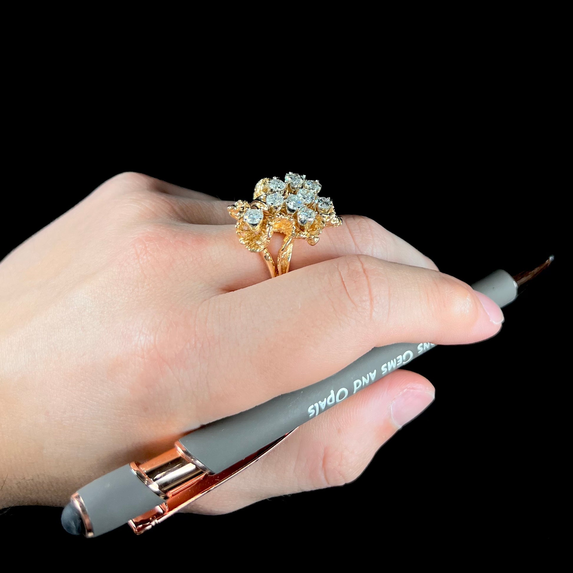 A ladies' 1950's style yellow gold and diamond cluster ring.  The ring is shaped like a leaf with 10 round diamonds set in it.