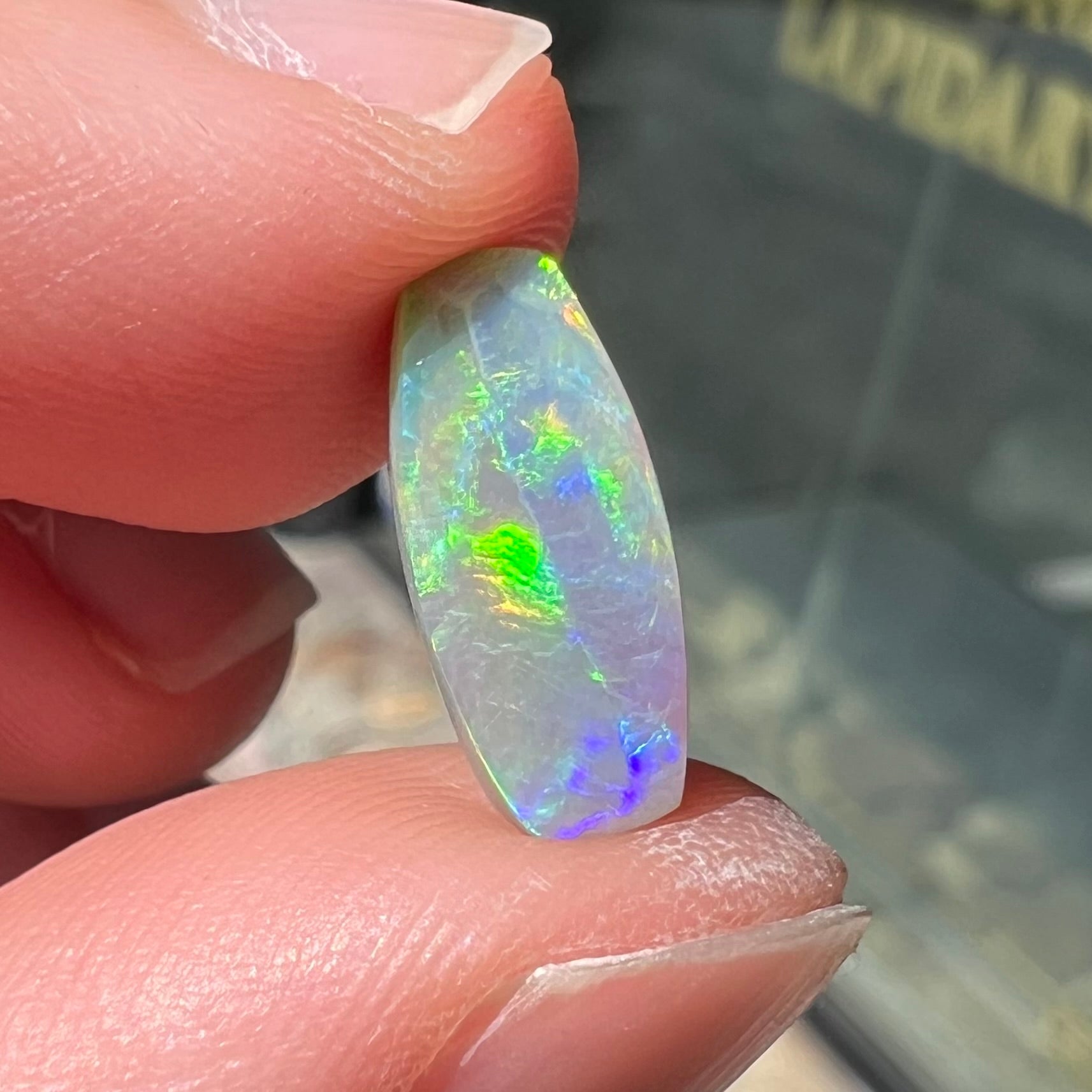 A loose, barrel shaped opal stone from Lightning Ridge, Australia.