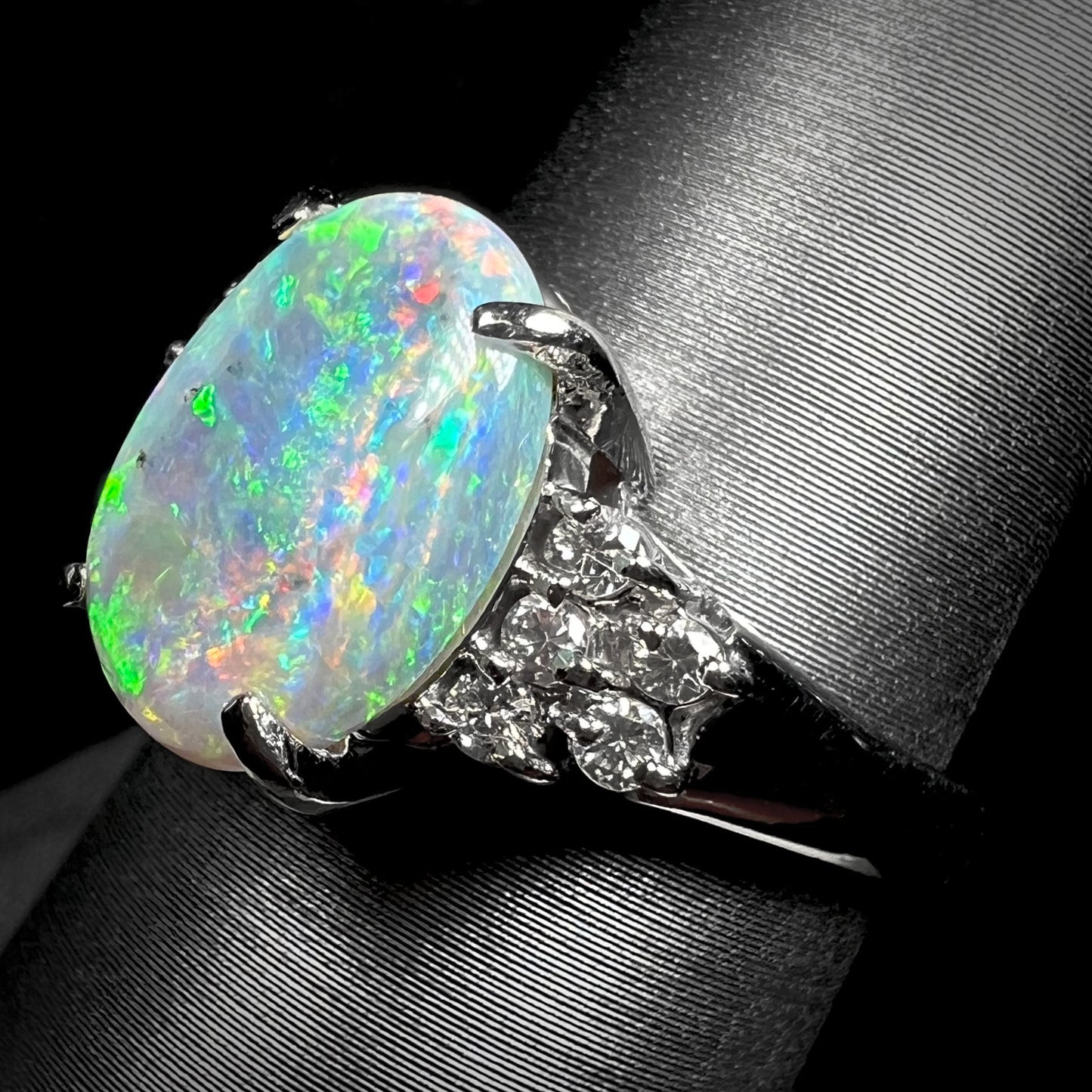 A multicolor Lightning Ridge opal and diamond-accented ring in platinum.