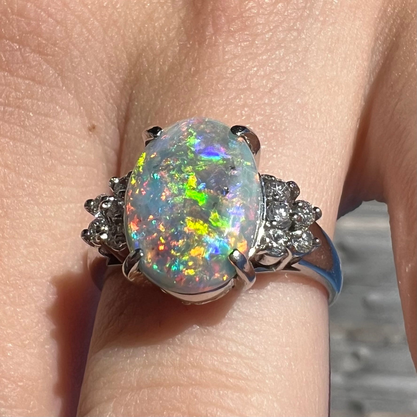 A multicolor Lightning Ridge opal and diamond-accented ring in platinum.