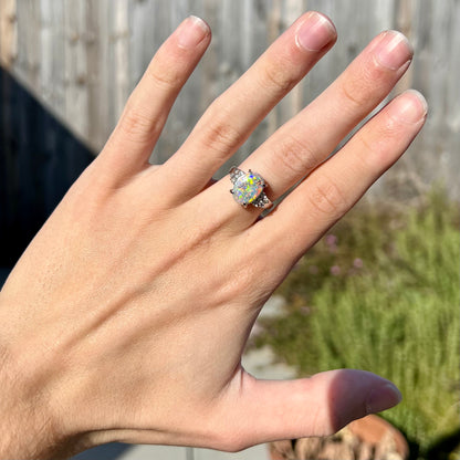 A multicolor Lightning Ridge opal and diamond-accented ring in platinum.