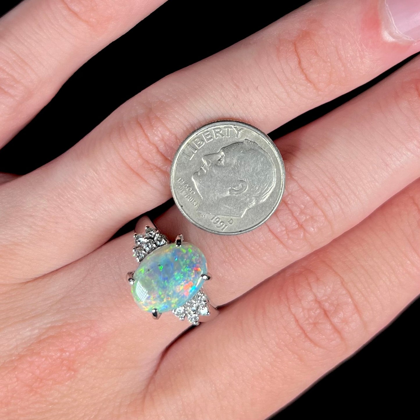 A multicolor Lightning Ridge opal and diamond-accented ring in platinum.