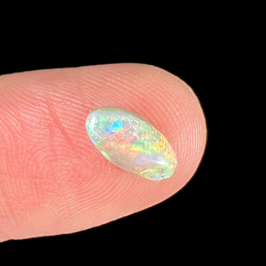 A loose, light opal from Lightning Ridge, Australia.  The opal shines a rainbow of colors.