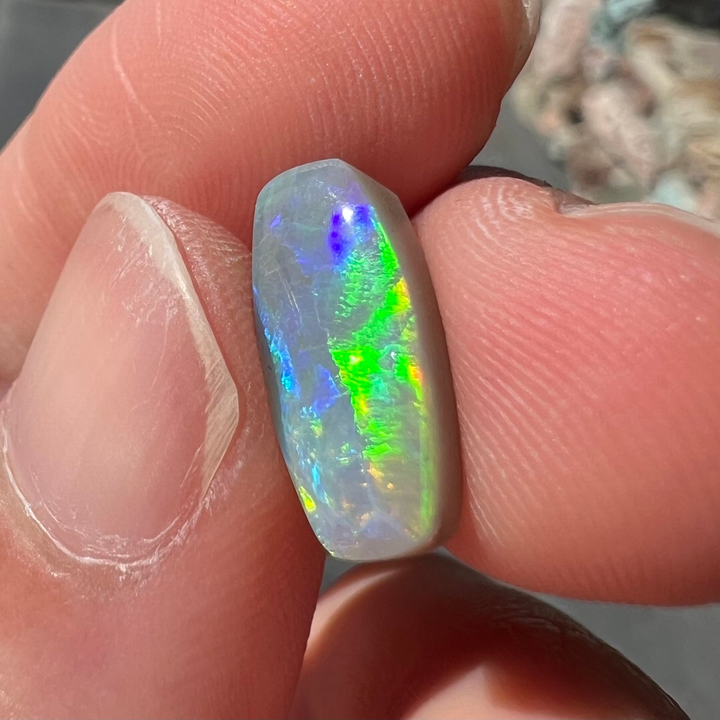 A loose, barrel shaped opal stone from Lightning Ridge, Australia.