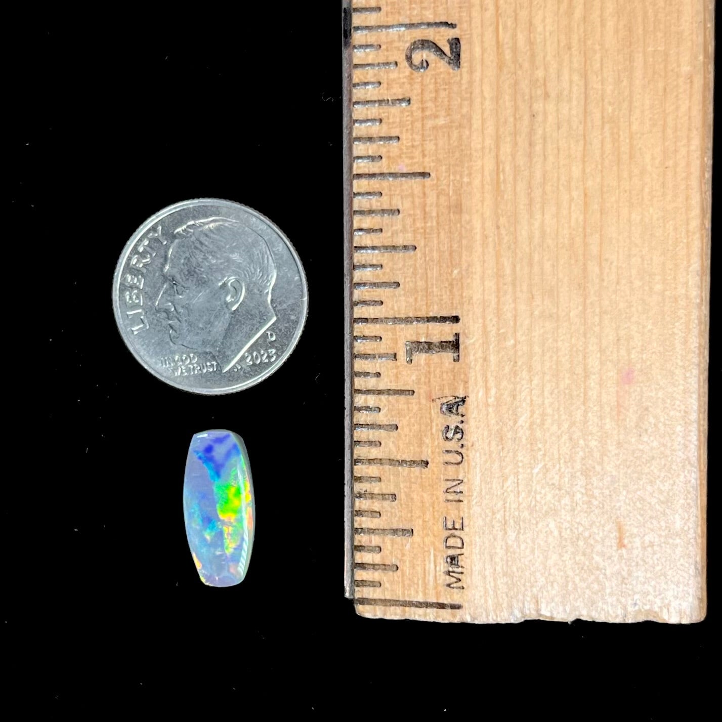 A loose, barrel shaped opal stone from Lightning Ridge, Australia.