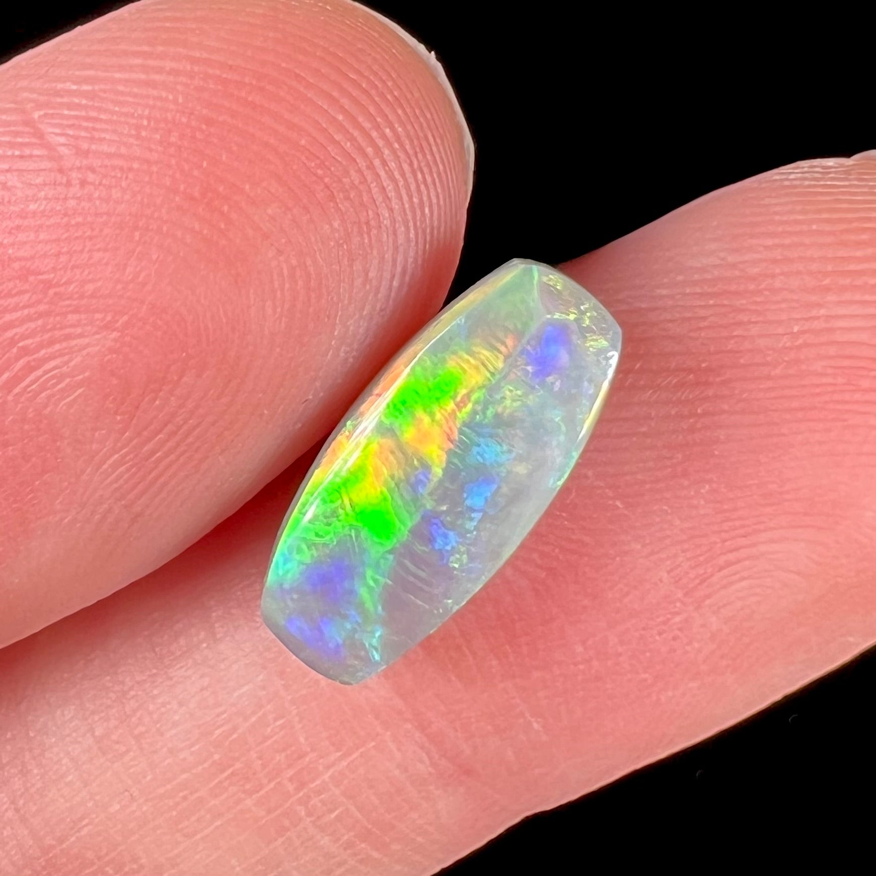 A loose, barrel shaped opal stone from Lightning Ridge, Australia.