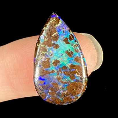 A pear shaped boulder opal from Koroit, Australia.