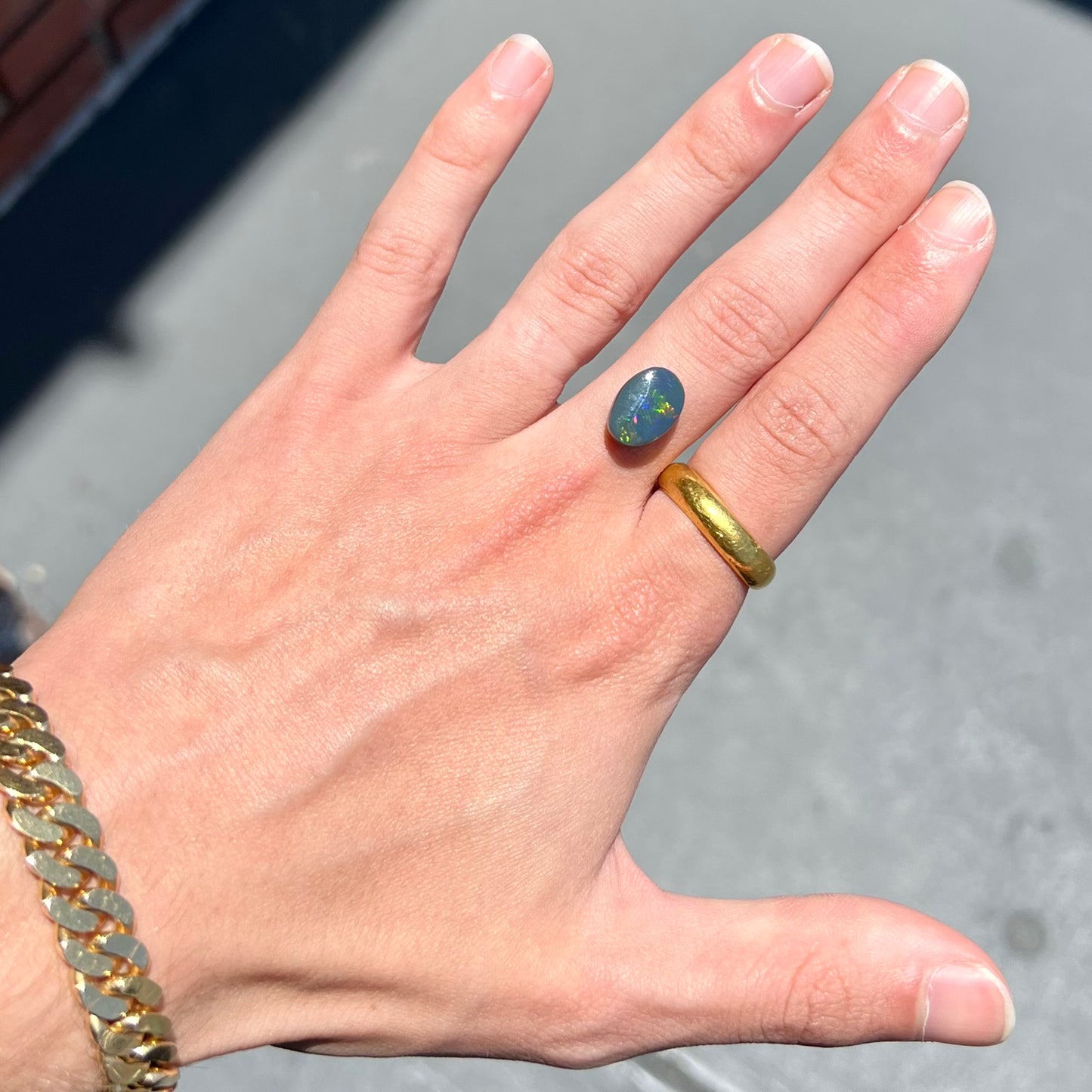 A loose, freeform cut black opal stone from Lightning Ridge, Australia.