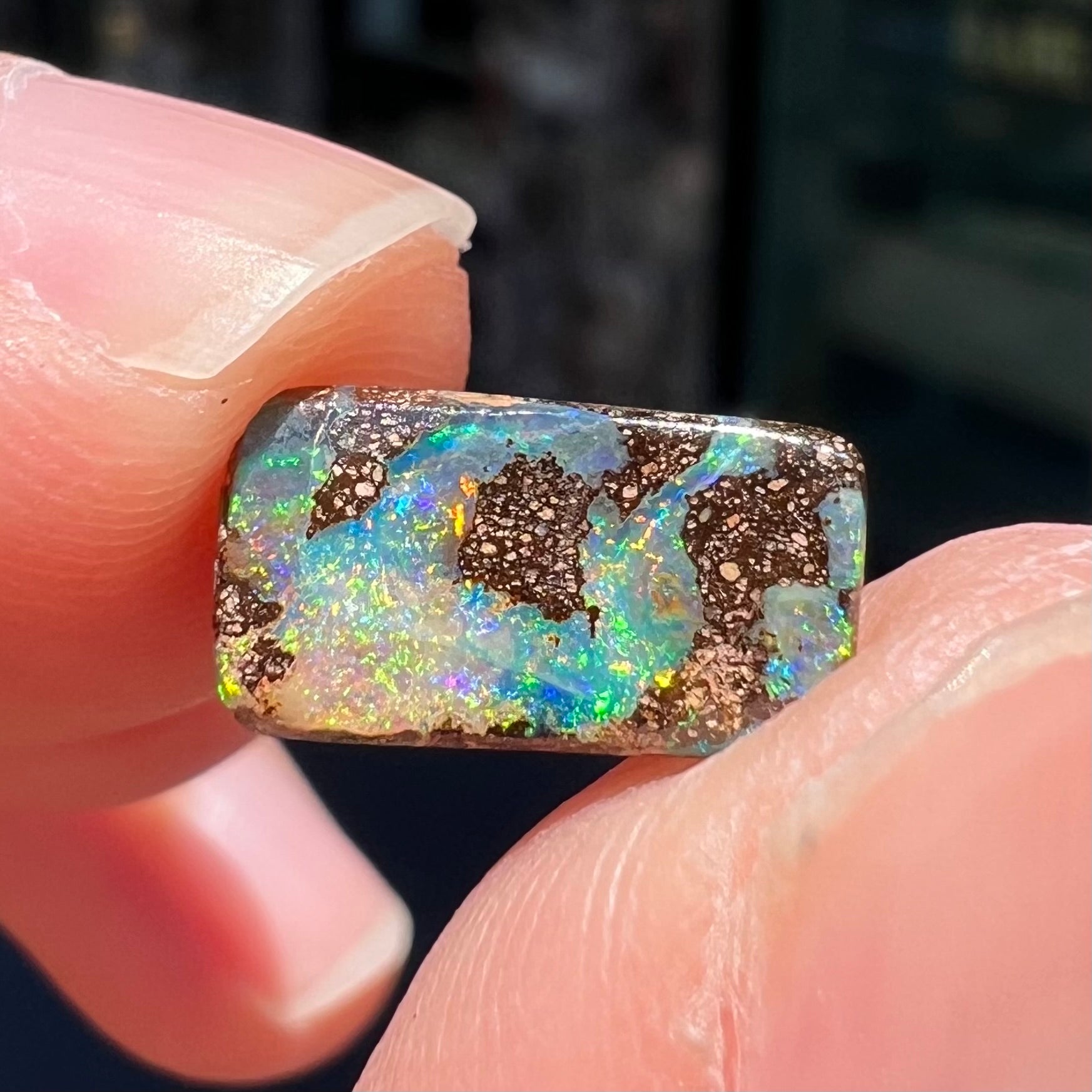 A loose, rectangular boulder opal stone from Quilpie, Australia.