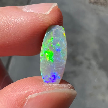 A loose, barrel shaped opal stone from Lightning Ridge, Australia.