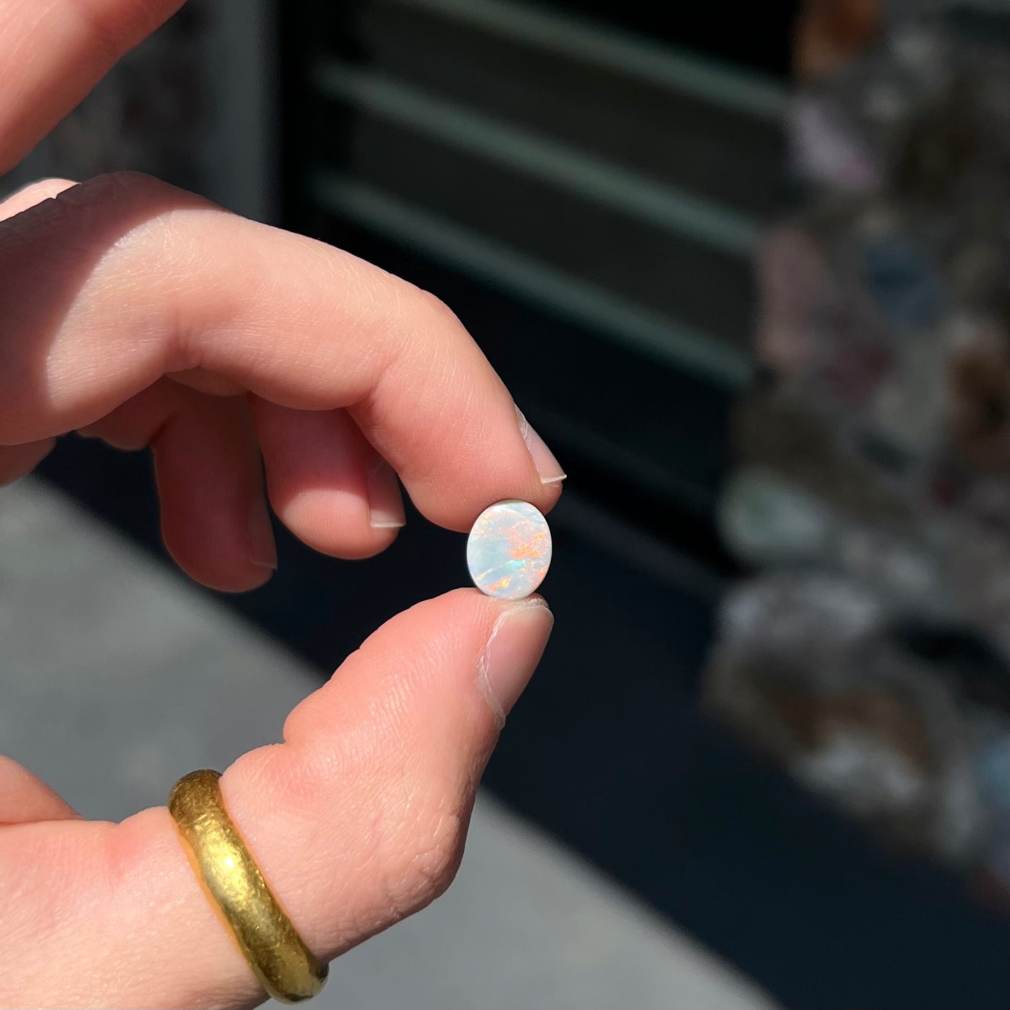 A loose, oval cabochon cut Lightning Ridge light opal stone.