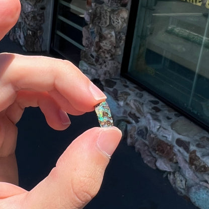 A loose, rectangular boulder opal stone from Quilpie, Australia.