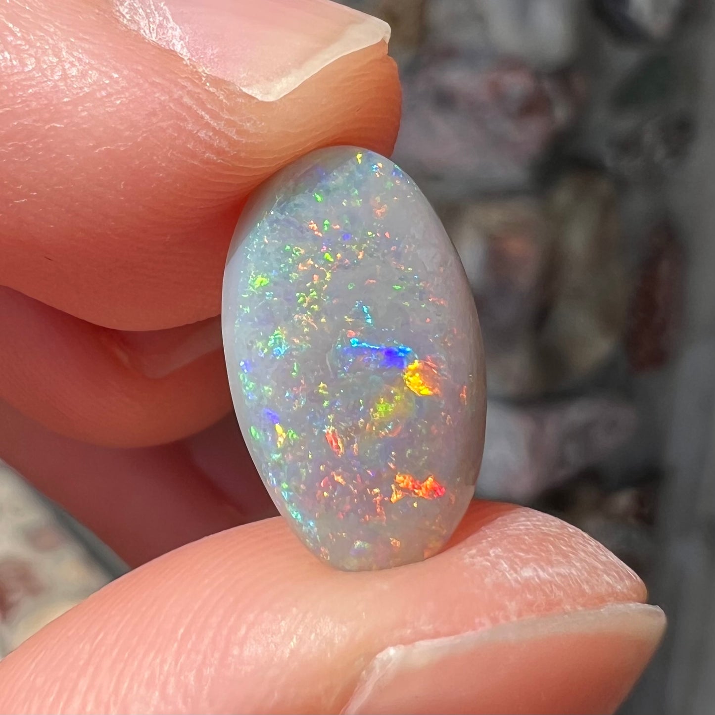 A semi-black, small flashfire opal stone from Mintabie, Australia.