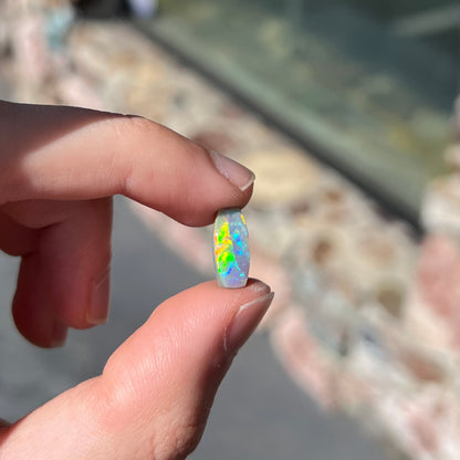 A loose, barrel shaped opal stone from Lightning Ridge, Australia.