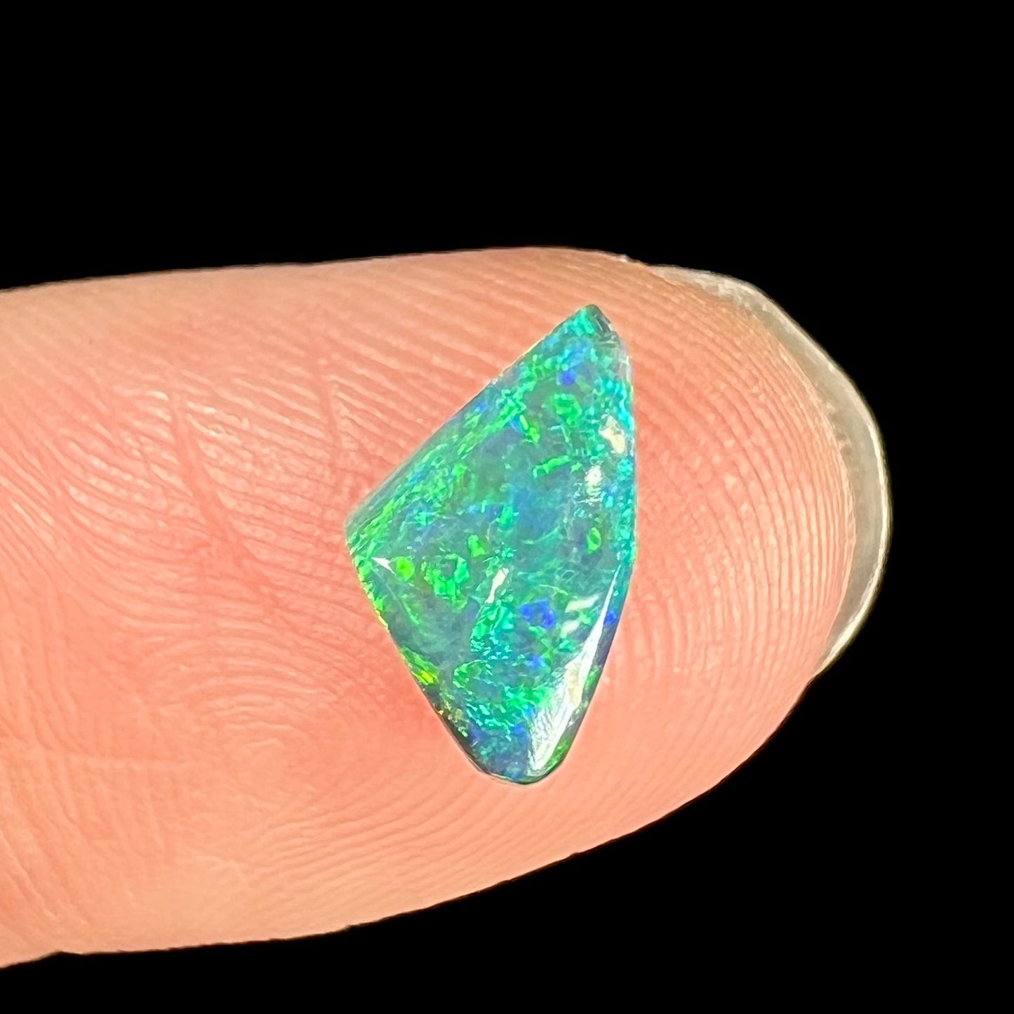 A vivid blue-green black opal stone from Lightning Ridge, Australia.