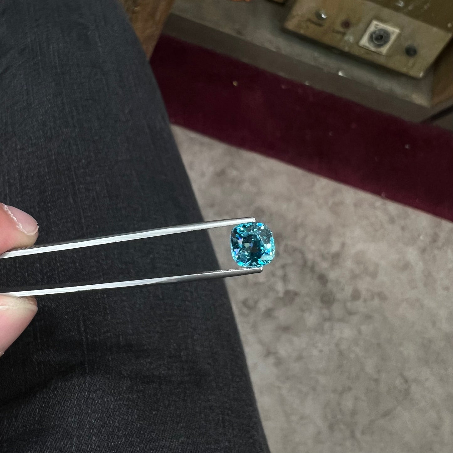 A loose cushion cut blue zircon stone.