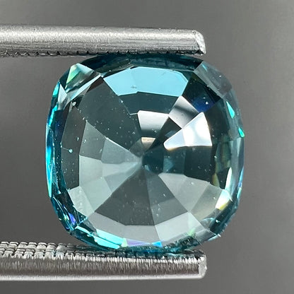 A loose cushion cut blue zircon stone.