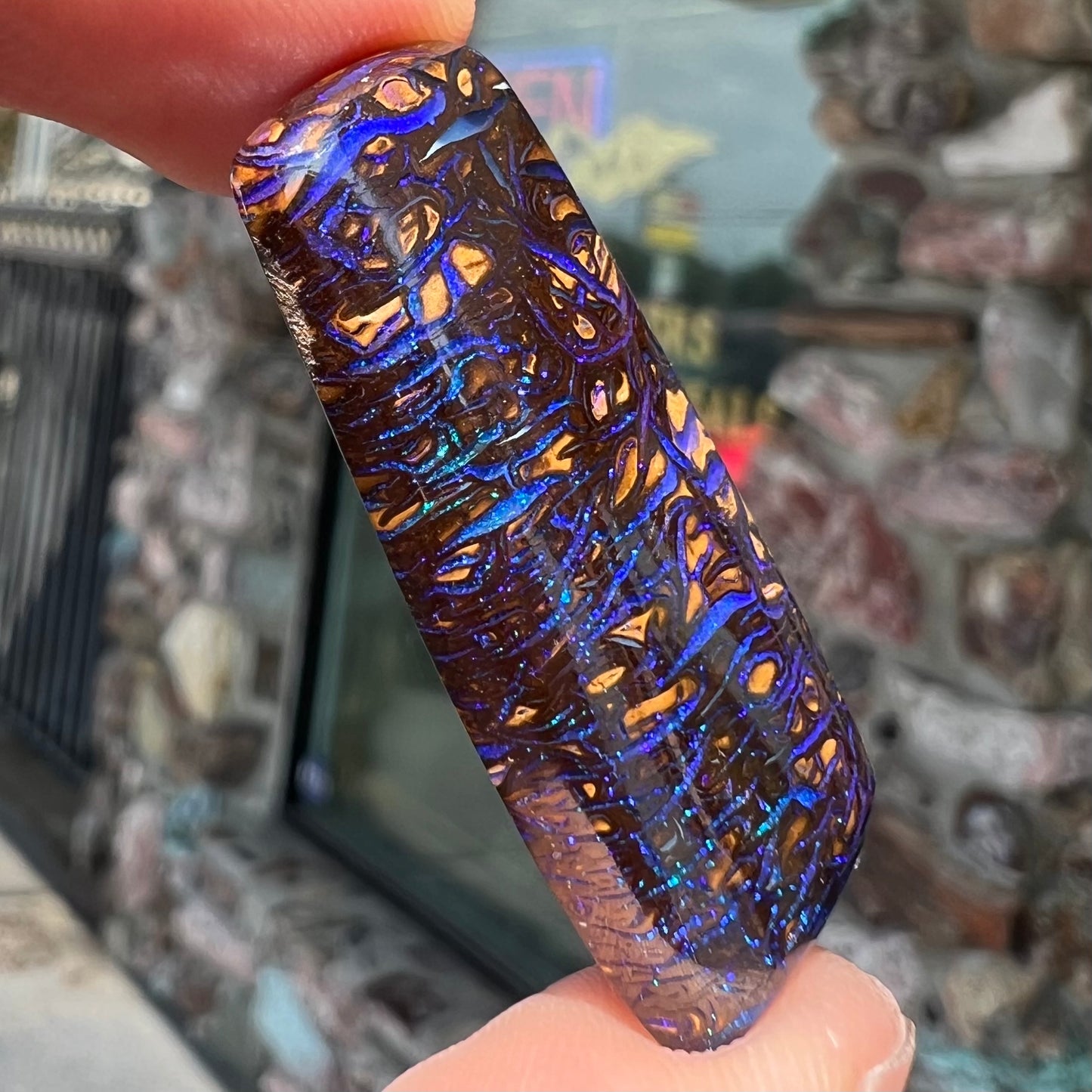 A loose boulder opal stone with purple veins from Koroit, Australia.