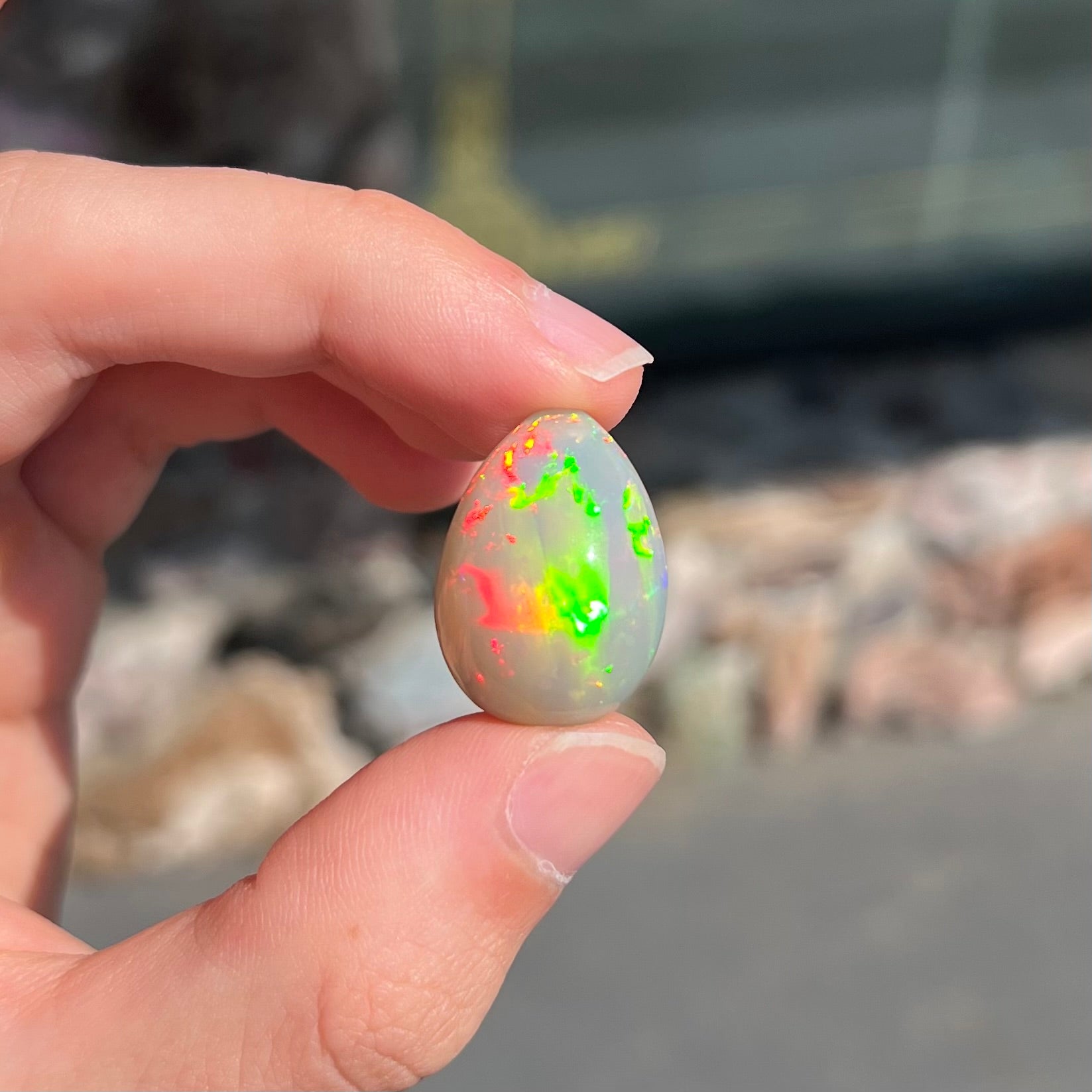 A pear shaped Ethiopian fire opal with vivid red and green play of color.