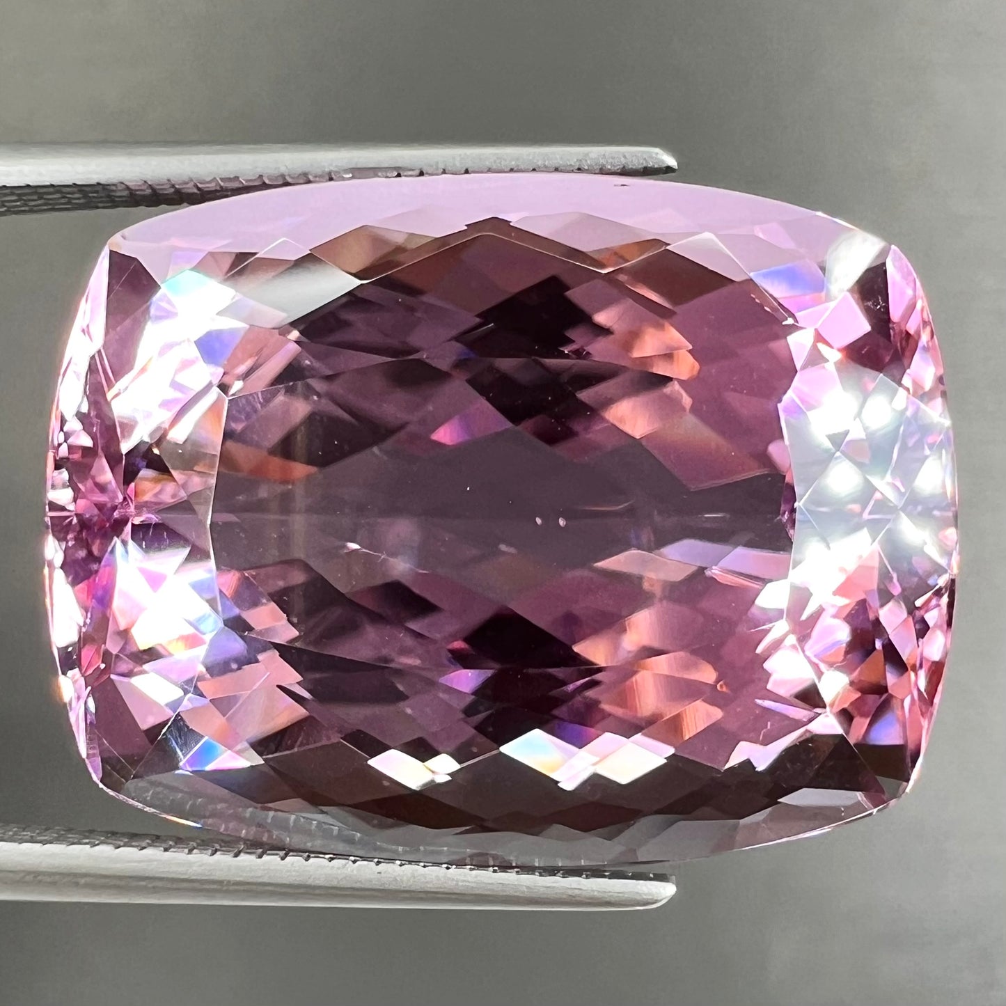 A modified cushion cut Afghanistan kunzite gemstone.  The stone is a purplish pink color and weighs 49.30 carats.