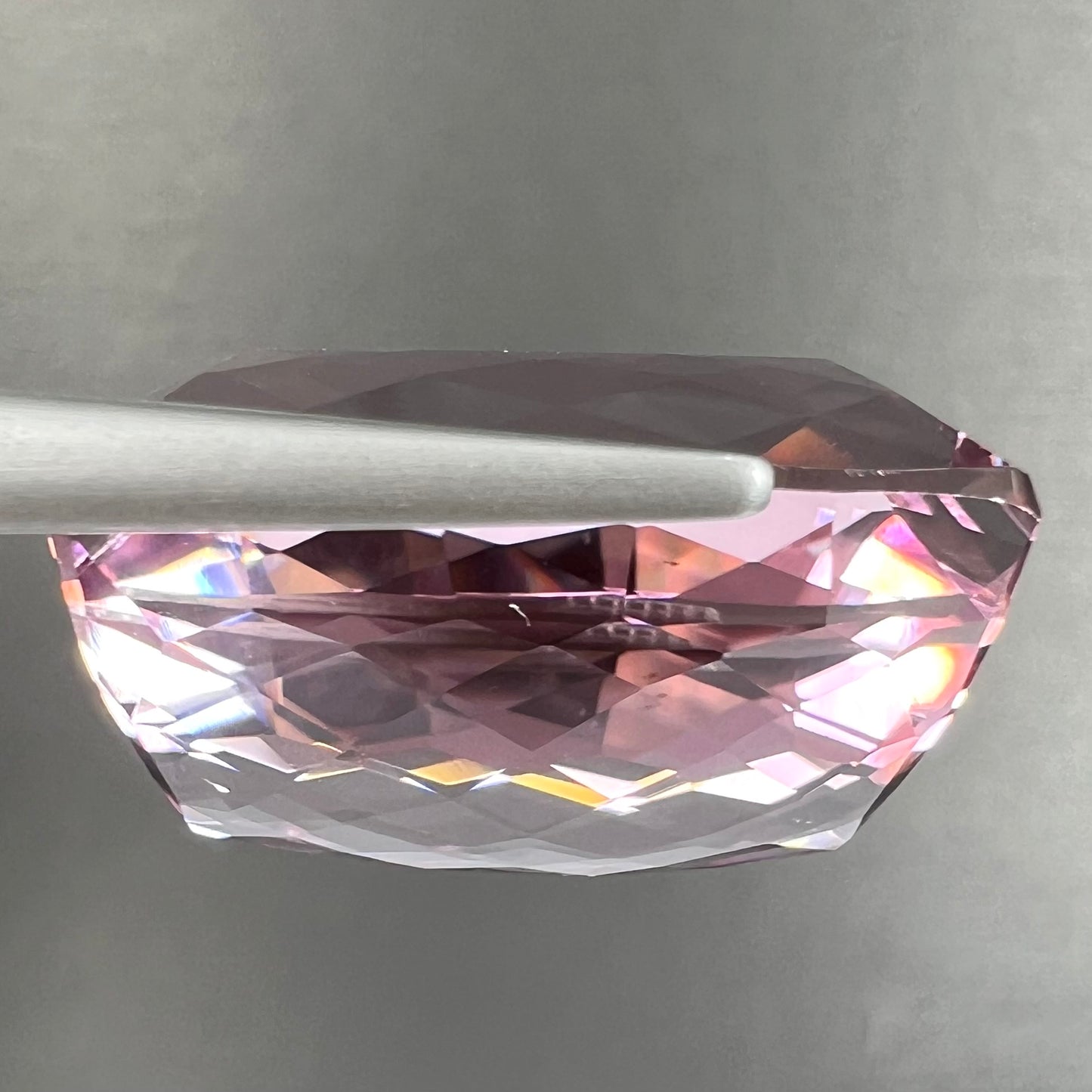 A modified cushion cut Afghanistan kunzite gemstone.  The stone is a purplish pink color and weighs 49.30 carats.