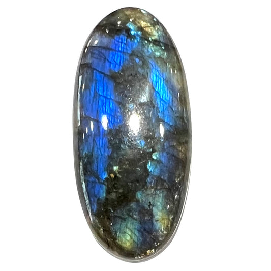 A loose, oval cabochon cut labradorite stone.  The stone is green with bright blue and yellow flashes.