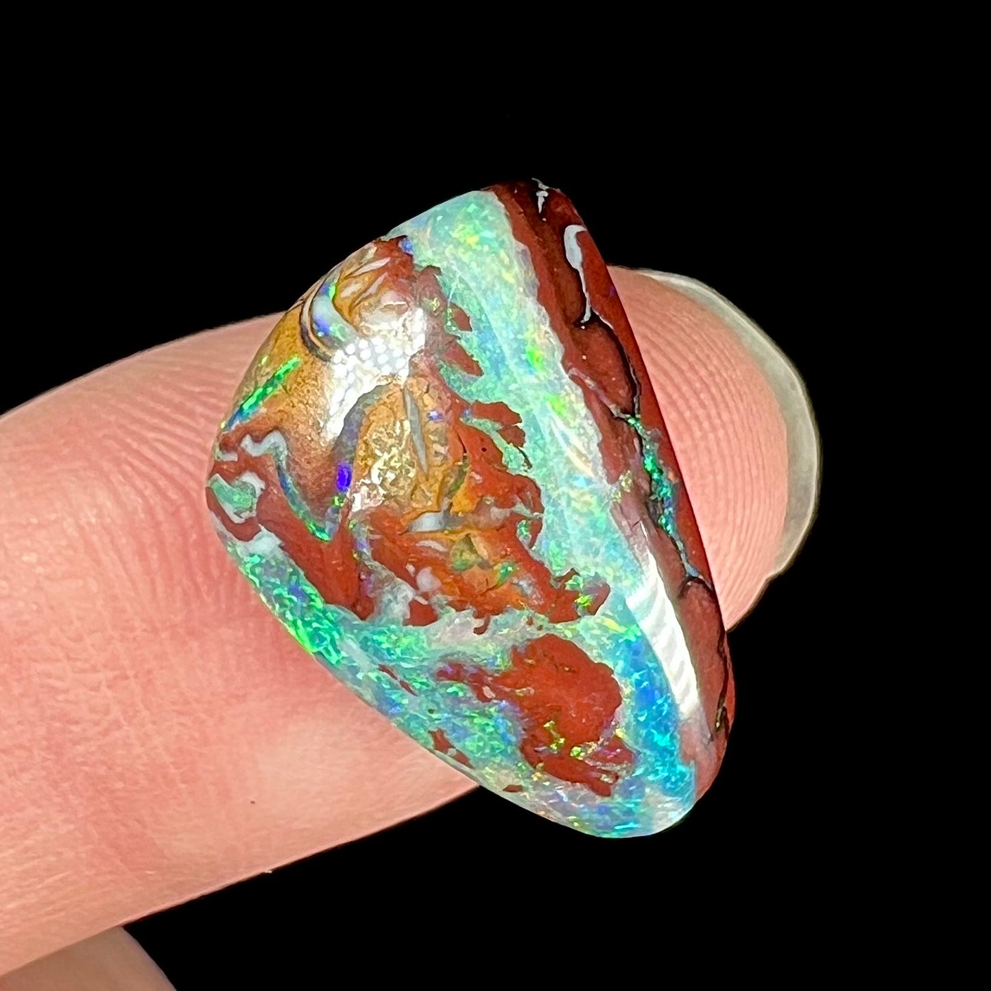 A polished matrix opal stone from Koroit, Australia.  The opal has a blue color.