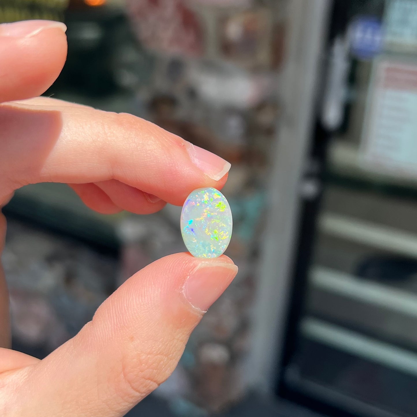 A double-sided opal stone from Coober Pedy, Australia.  The opal plays green, blue, and orange colors from the front and the back.