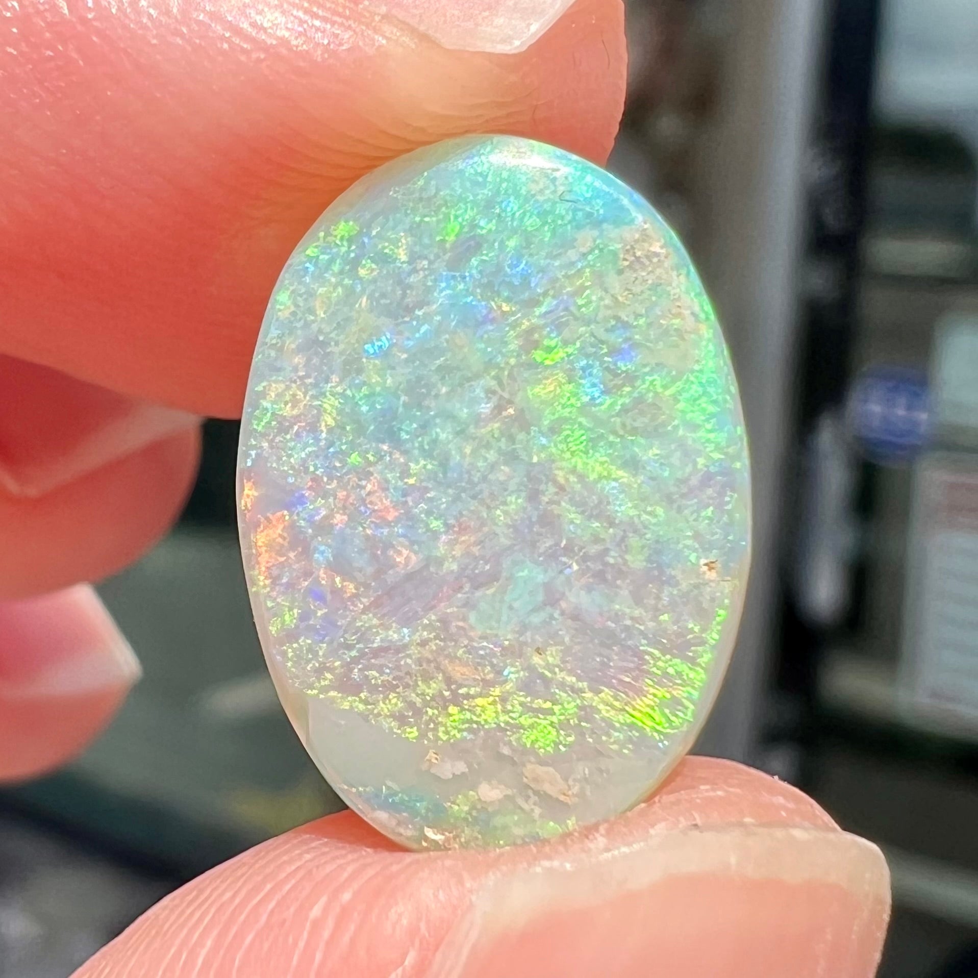 A double-sided opal stone from Coober Pedy, Australia.  The opal plays green, blue, and orange colors from the front and the back.