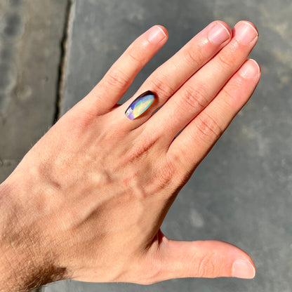 A 6.32ct Brazilian opal stone.  The opal has a green and blue rain pattern.