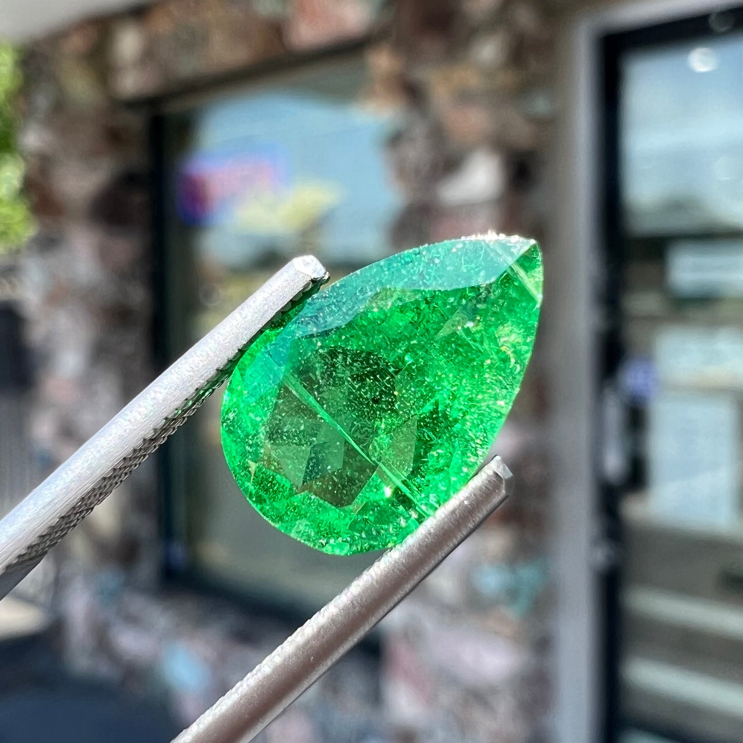 A loose, pear shaped tsavorite garnet gemstone.  The stone is vivid green color.