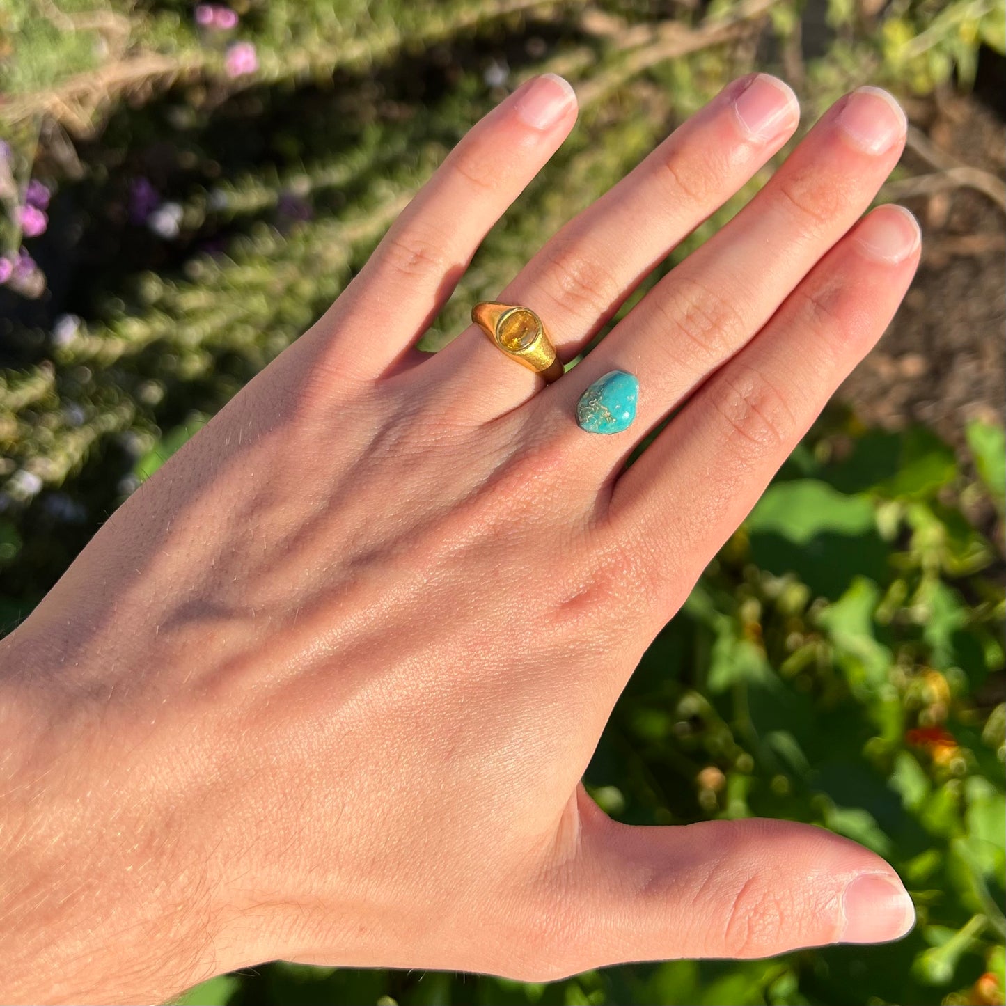 A loose, freeform cut Pilot Mountain turquoise cabochon.  The stone is greenish blue.