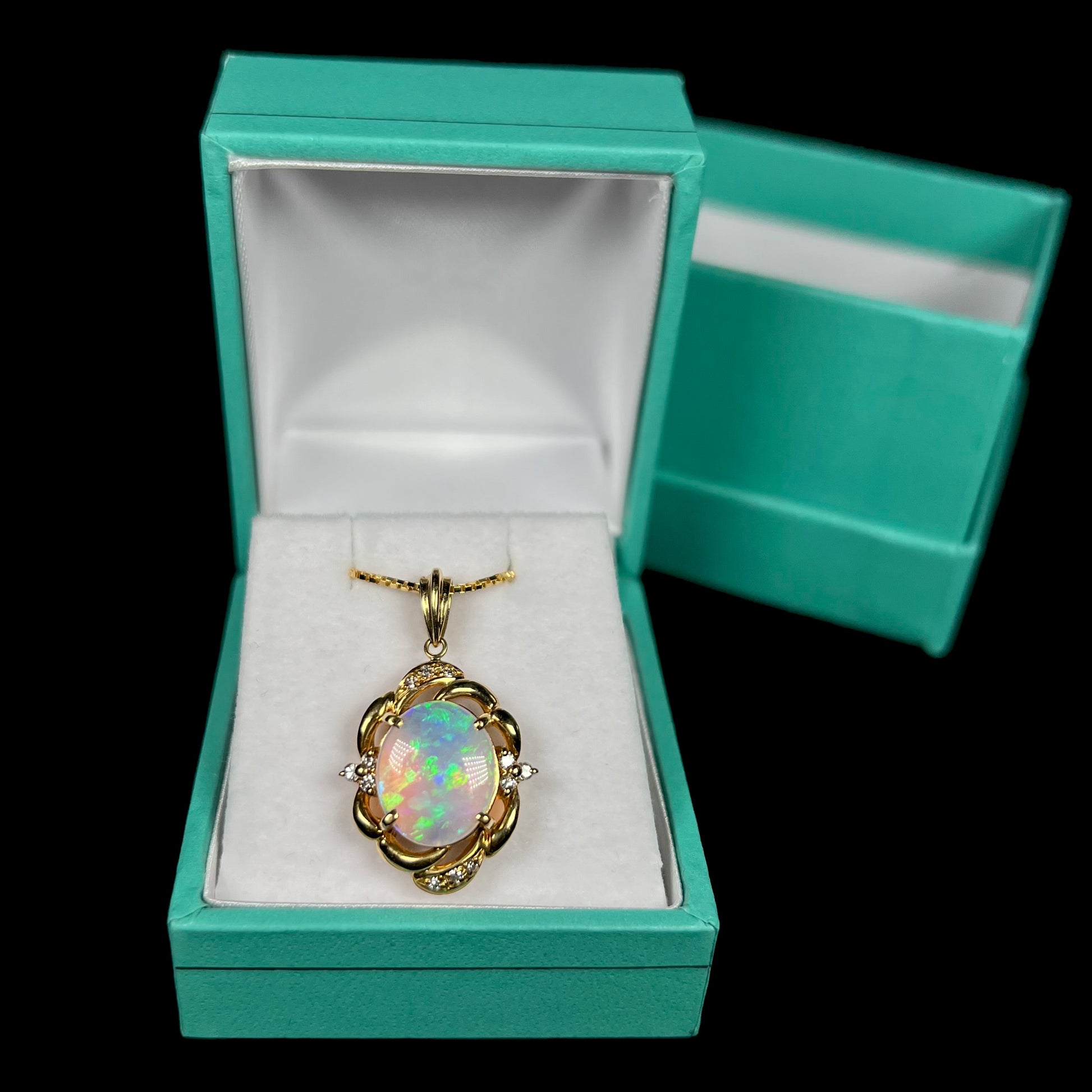 An 18 karat yellow gold diamond-accented necklace mounted with a green and blue Lightning Ridge crystal opal.