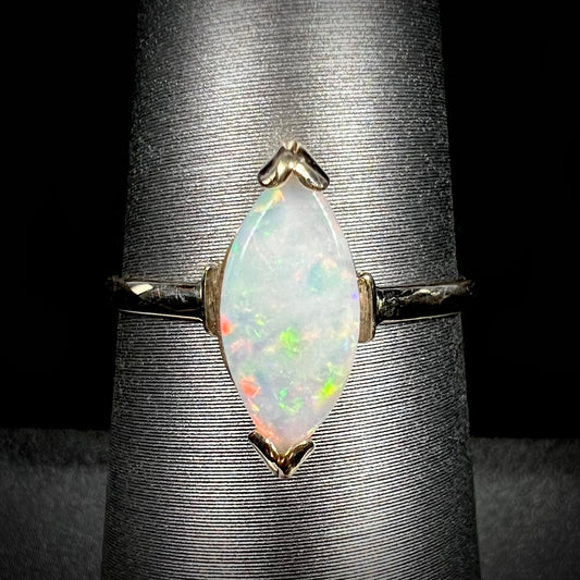 A marquise cut natural opal solitaire ring in yellow gold.