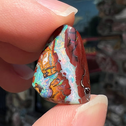 A polished matrix opal stone from Koroit, Australia.  The opal has a blue color.