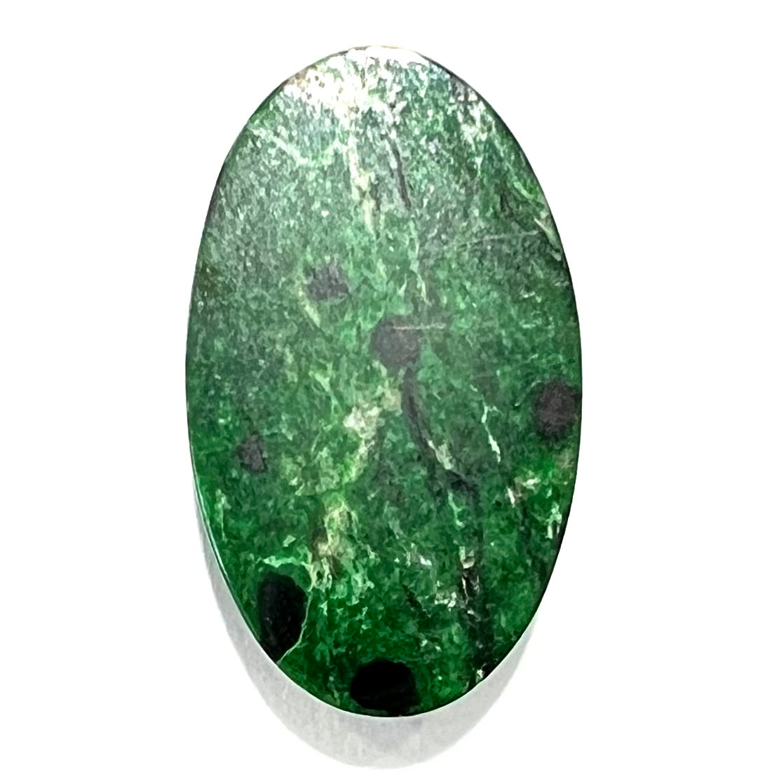 A loose, oval cabochon cut green maw sit sit stone.