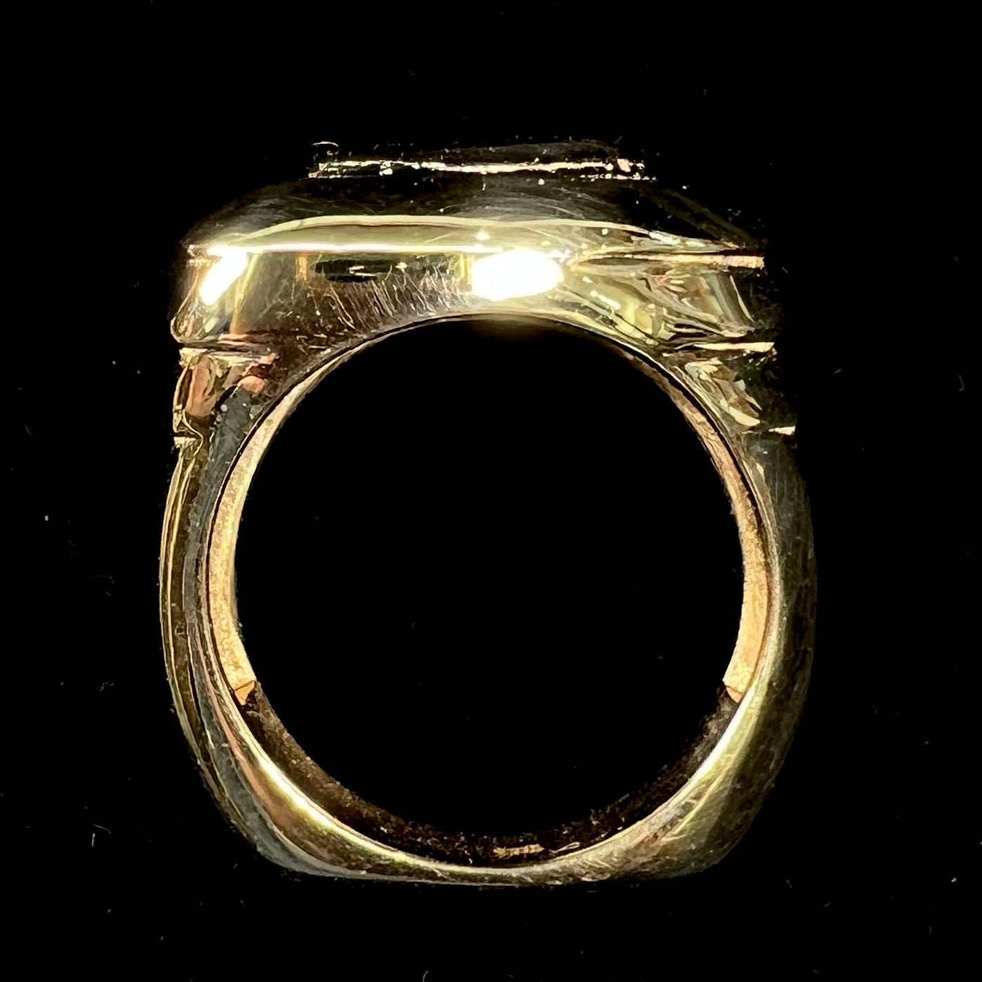 A custom, solid yellow gold men's ring cast with a squared European-style shank.